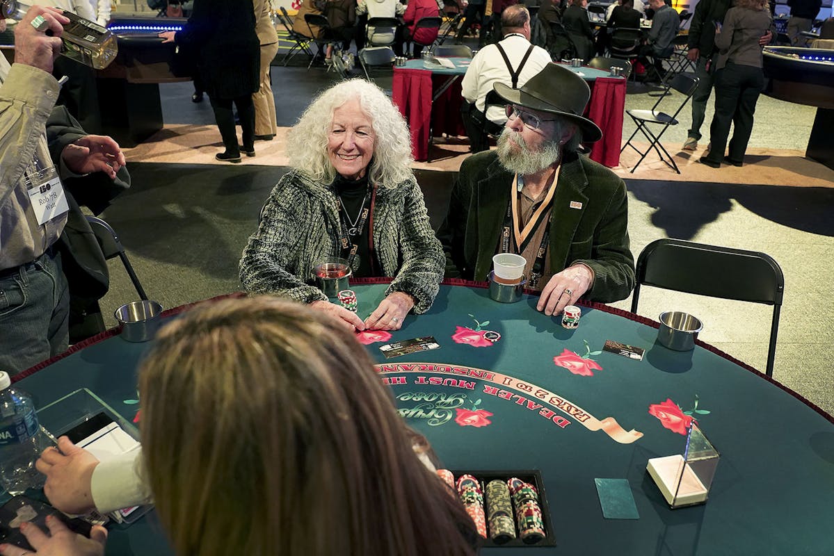 Jay Rodman '74, right, and his wife, Wendy Wilkins, left, gamble during the Homecoming Extravaganza on Nov. 2 at Robson. Photo by Jamie Cotten / Colorado College